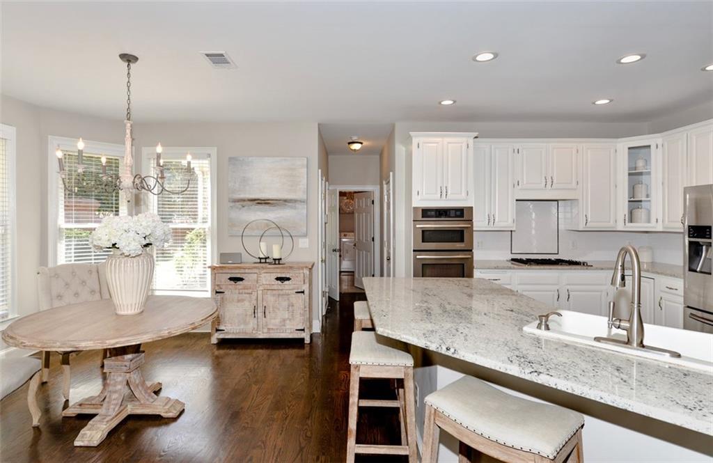310 Windsor Gate Cove Northeast Atlanta, GA 30342 - Photo 21 of 58 a large kitchen with lots of counter space and furniture