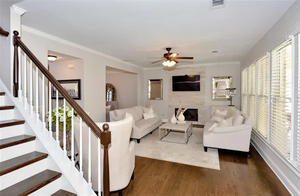 a living room with furniture a fireplace and a flat screen tv