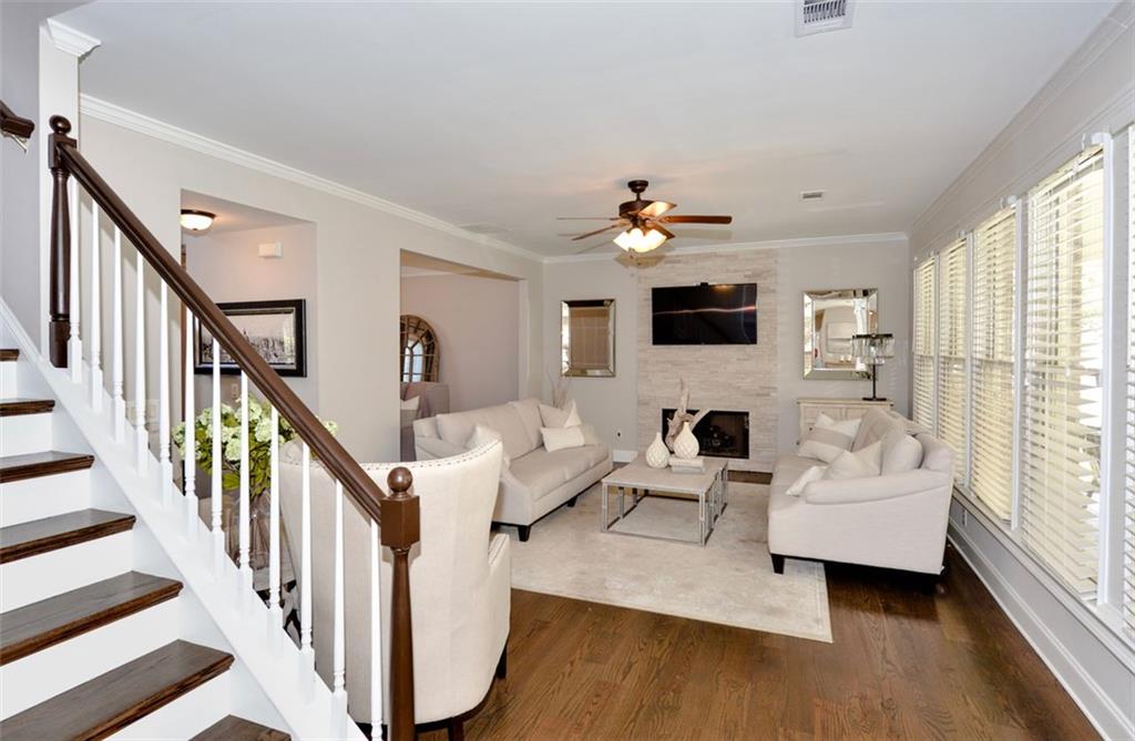 310 Windsor Gate Cove Northeast Atlanta, GA 30342 - Photo 24 of 58 a living room with furniture and a flat screen tv