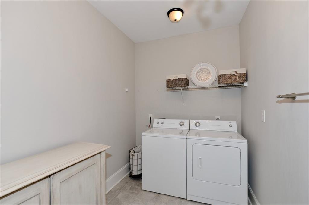 310 Windsor Gate Cove Northeast Atlanta, GA 30342 - Photo 29 of 58 a utility room with dryer and washer