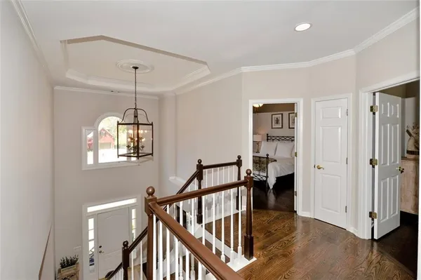 a living room with furniture a flat screen tv and a window