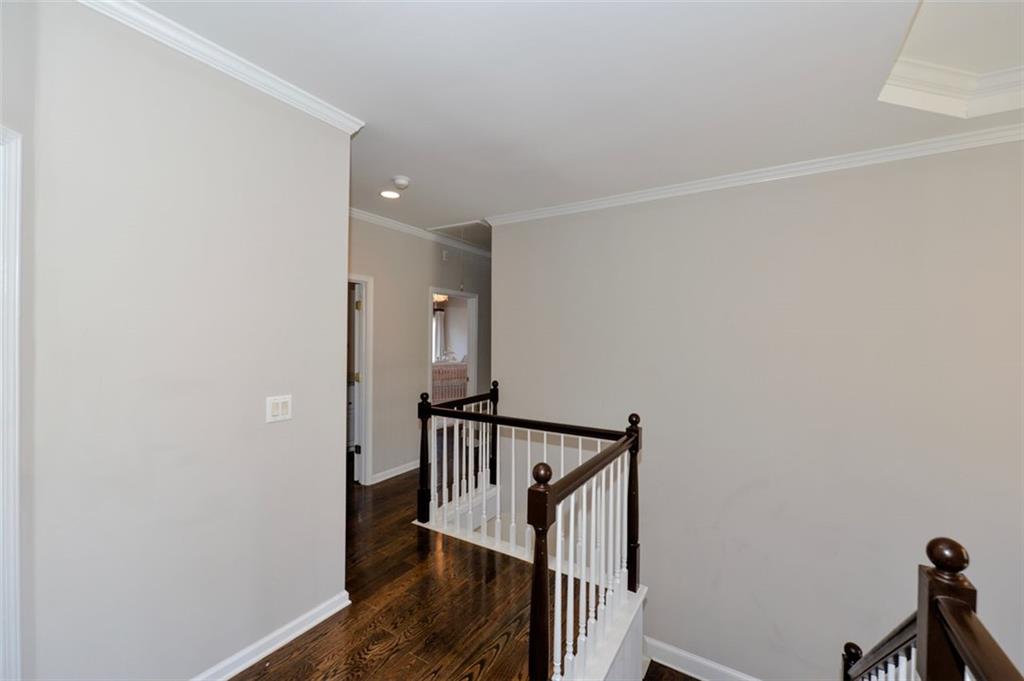310 Windsor Gate Cove Northeast Atlanta, GA 30342 - Photo 33 of 58 a view of a hallway with wooden floor