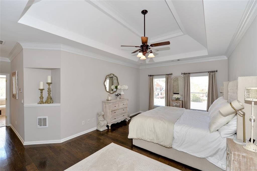 310 Windsor Gate Cove Northeast Atlanta, GA 30342 - Photo 34 of 58 a bedroom with a bed and a chandelier