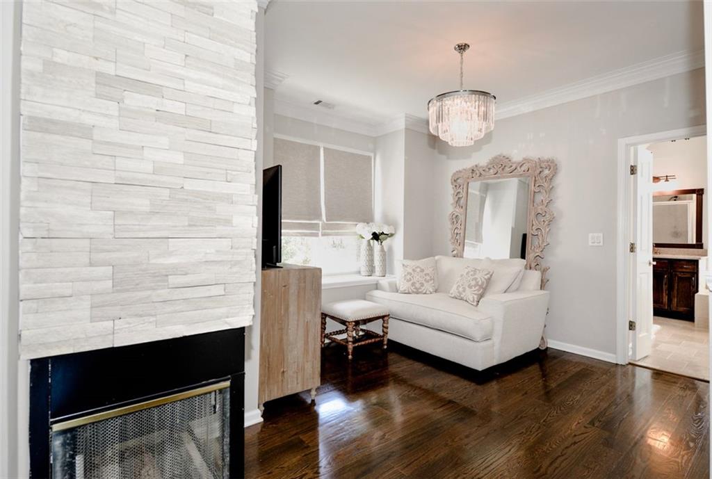 310 Windsor Gate Cove Northeast Atlanta, GA 30342 - Photo 35 of 58 a living room with furniture wooden floor and a chandelier