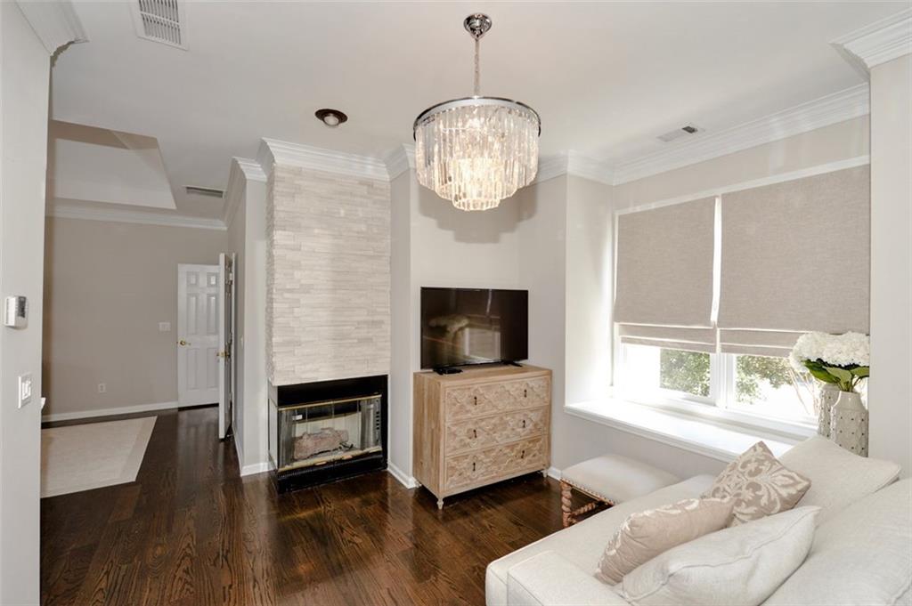 310 Windsor Gate Cove Northeast Atlanta, GA 30342 - Photo 38 of 58 a living room with furniture wooden floor and a flat screen tv