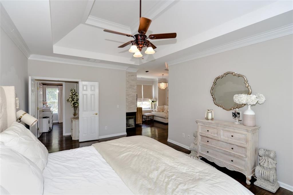 310 Windsor Gate Cove Northeast Atlanta, GA 30342 - Photo 39 of 58 a bedroom with a bed and wooden floor