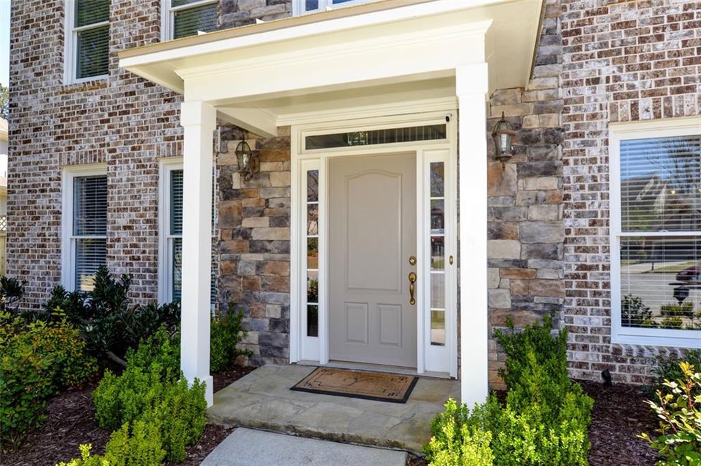 310 Windsor Gate Cove Northeast Atlanta, GA 30342 - Photo 4 of 58 a front view of a house with a glass door