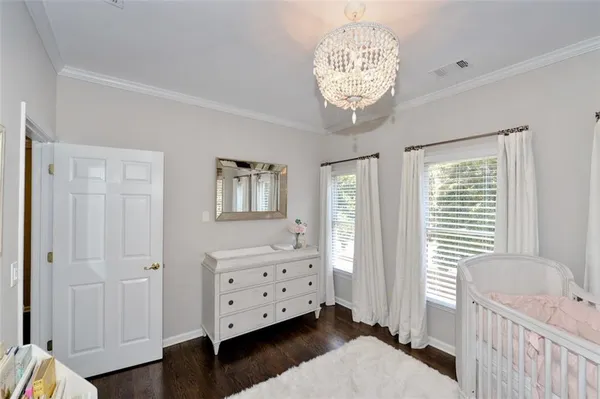 a dining room with furniture large windows and a chandelier