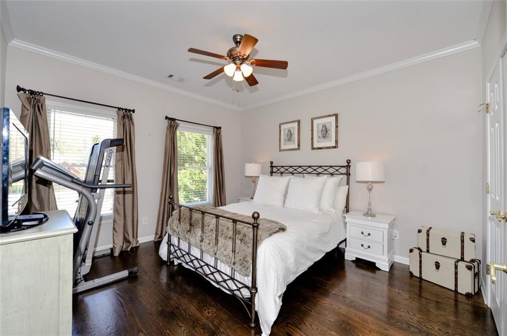 310 Windsor Gate Cove Northeast Atlanta, GA 30342 - Photo 46 of 58 a bed sitting in a bedroom next to a window