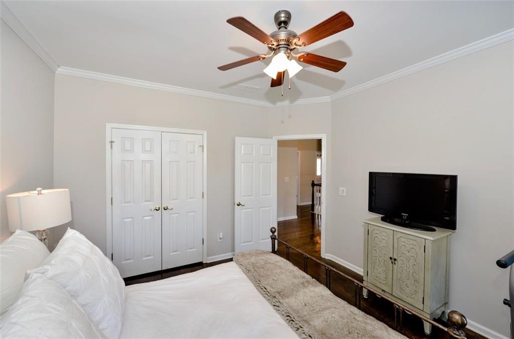 310 Windsor Gate Cove Northeast Atlanta, GA 30342 - Photo 47 of 58 a living room with a flat screen tv and a ceiling fan