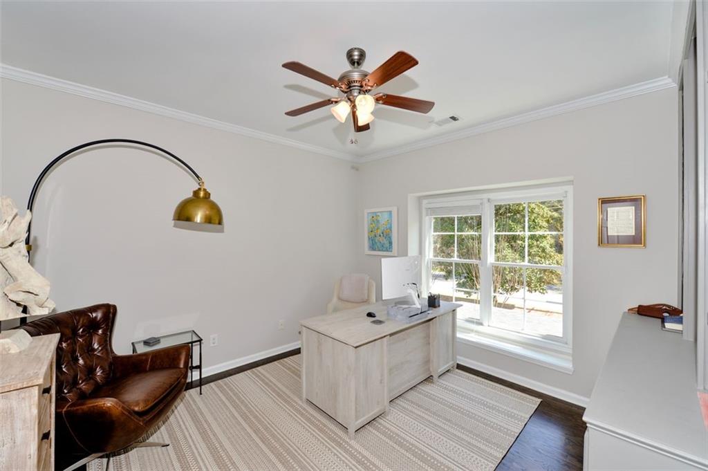 310 Windsor Gate Cove Northeast Atlanta, GA 30342 - Photo 48 of 58 a living room with a ceiling fan furniture and a window