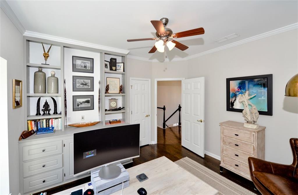 310 Windsor Gate Cove Northeast Atlanta, GA 30342 - Photo 49 of 58 a living room with furniture and book shelf