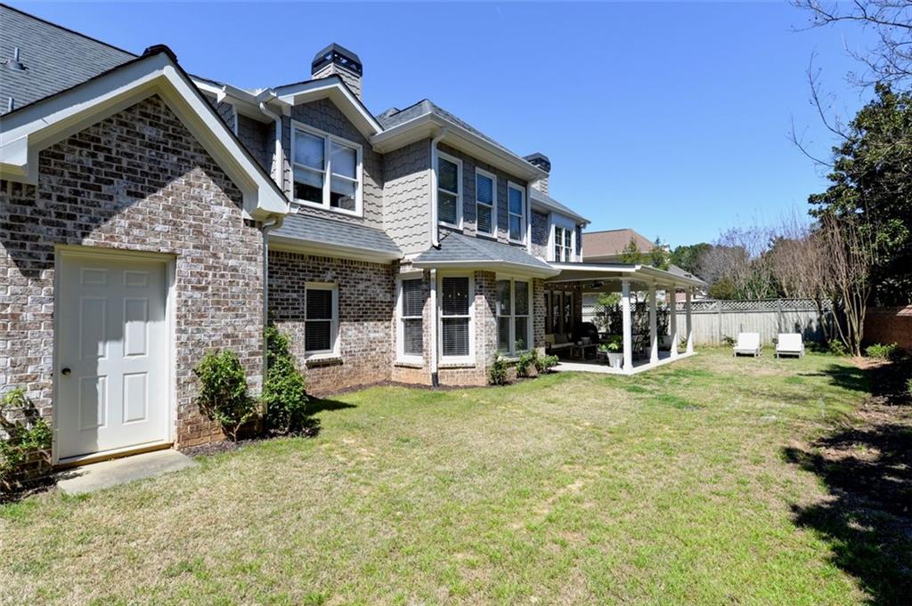 310 Windsor Gate Cove Northeast Atlanta, GA 30342 - Photo 5 of 58 front view of a house with a yard