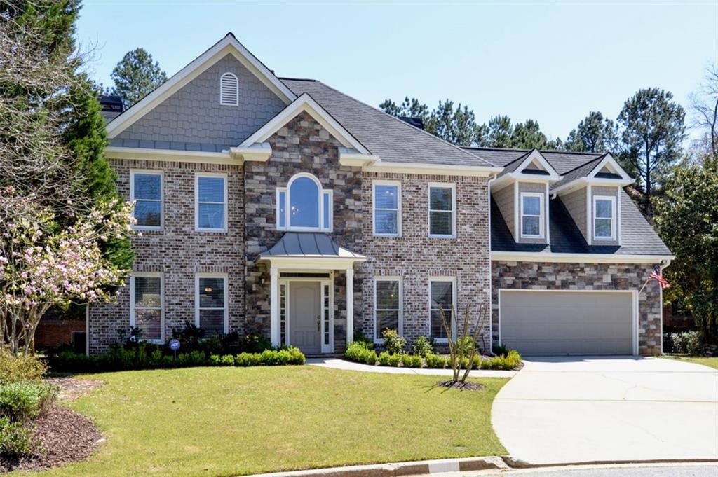 310 Windsor Gate Cove Northeast Atlanta, GA 30342 - Photo 52 of 58 a front view of a house with a yard