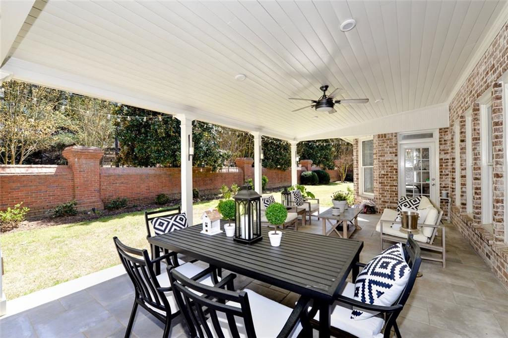310 Windsor Gate Cove Northeast Atlanta, GA 30342 - Photo 53 of 58 a dining room with furniture large windows and a chandelier