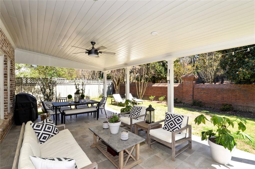 310 Windsor Gate Cove Northeast Atlanta, GA 30342 - Photo 54 of 58 a outdoor space with patio the couches and a dining table with the view of garden