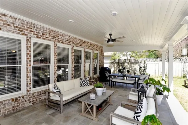 a view of a house with backyard porch and sitting area