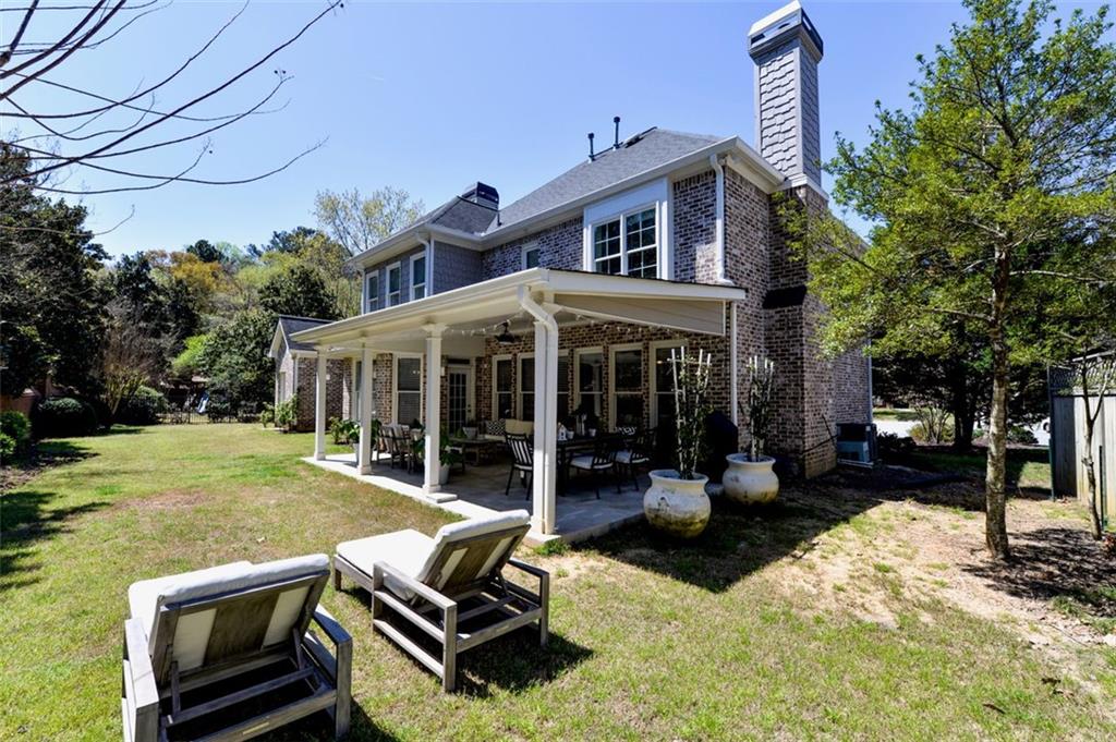 310 Windsor Gate Cove Northeast Atlanta, GA 30342 - Photo 9 of 58 a view of a house with backyard porch and sitting area