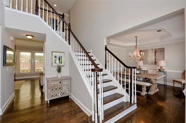 a view of a dining room with furniture wooden floor and chandelier