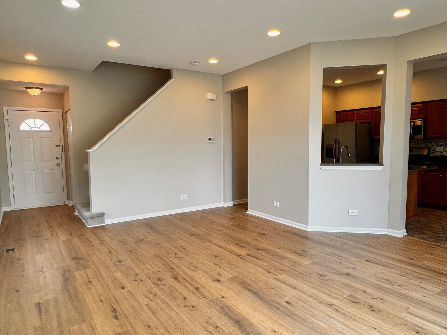 1617 Spaulding Road Bartlett, IL 60103 - Photo 3 of 10 a view of an empty room with wooden floor and entryway