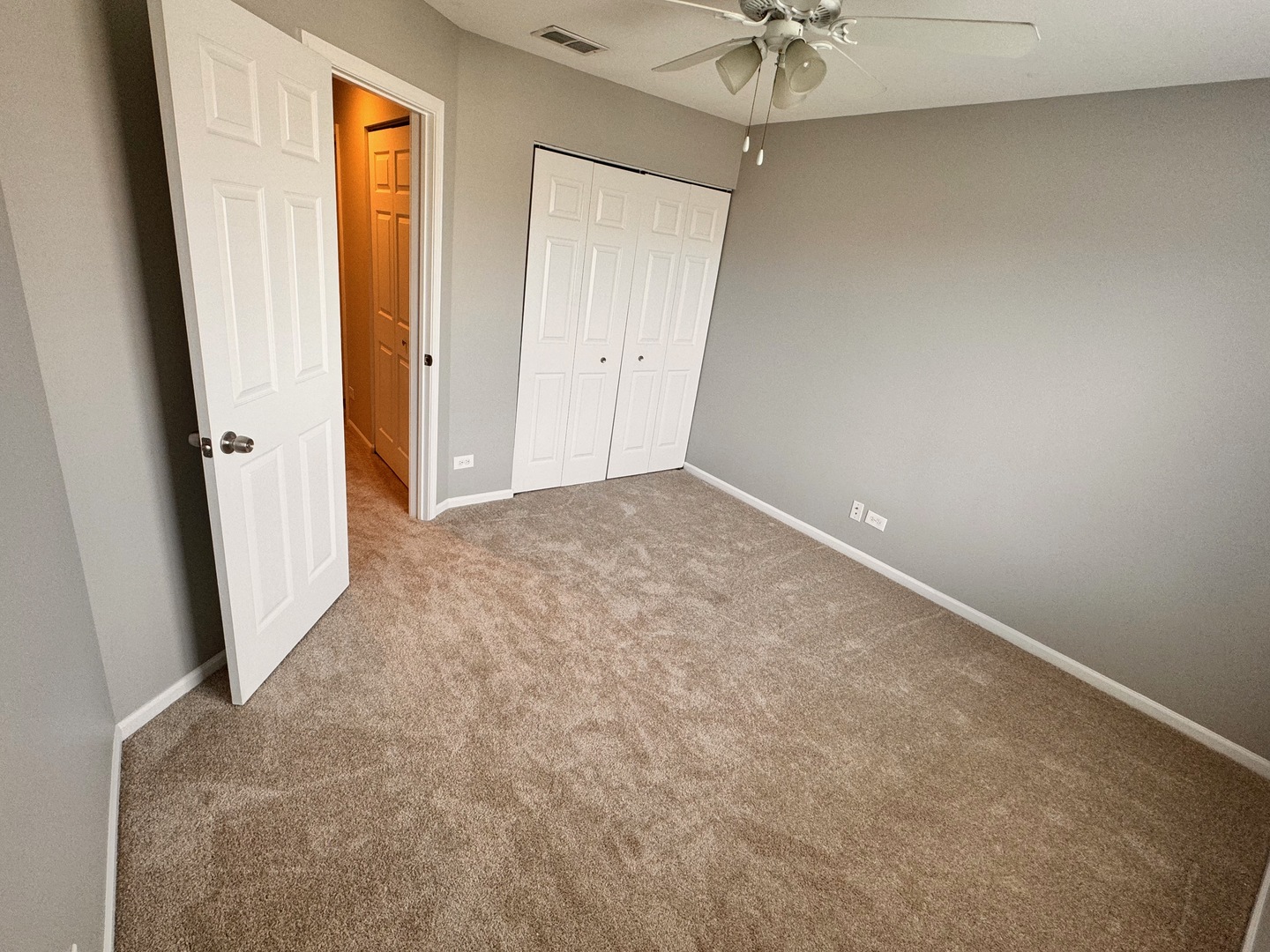 1617 Spaulding Road Bartlett, IL 60103 - Photo 8 of 10 an empty room with a window and a ceiling fan