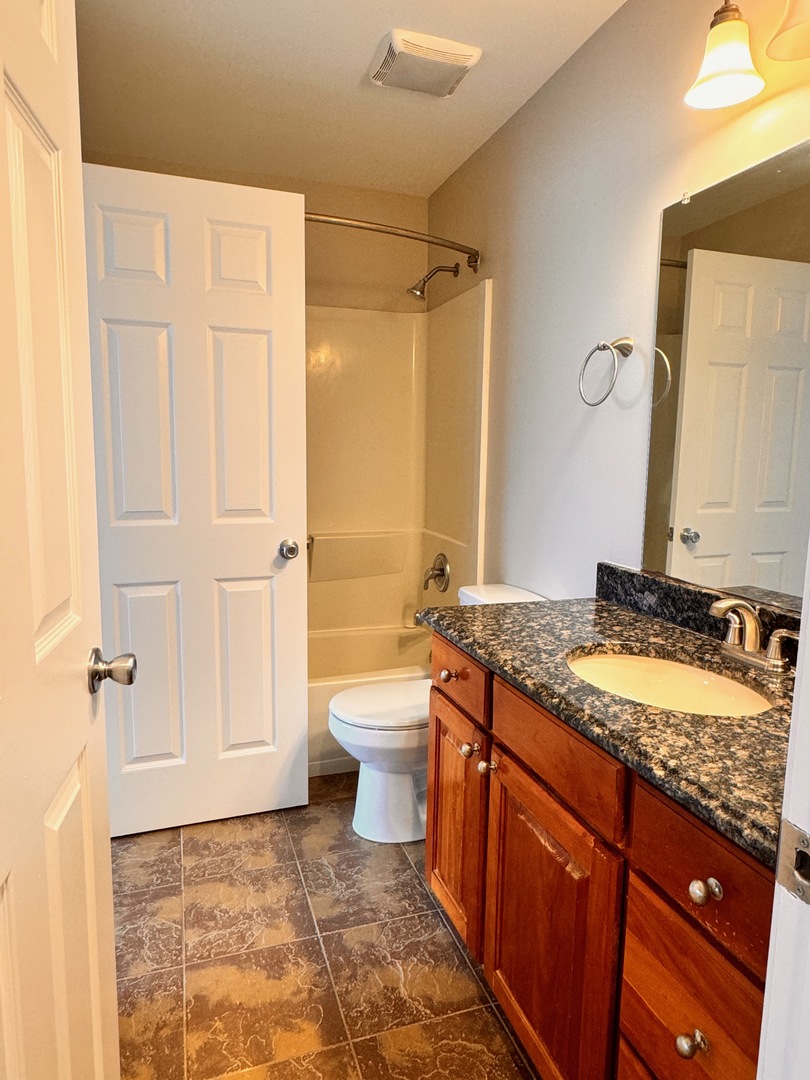 1617 Spaulding Road Bartlett, IL 60103 - Photo 10 of 10 a bathroom with a granite countertop sink toilet and shower