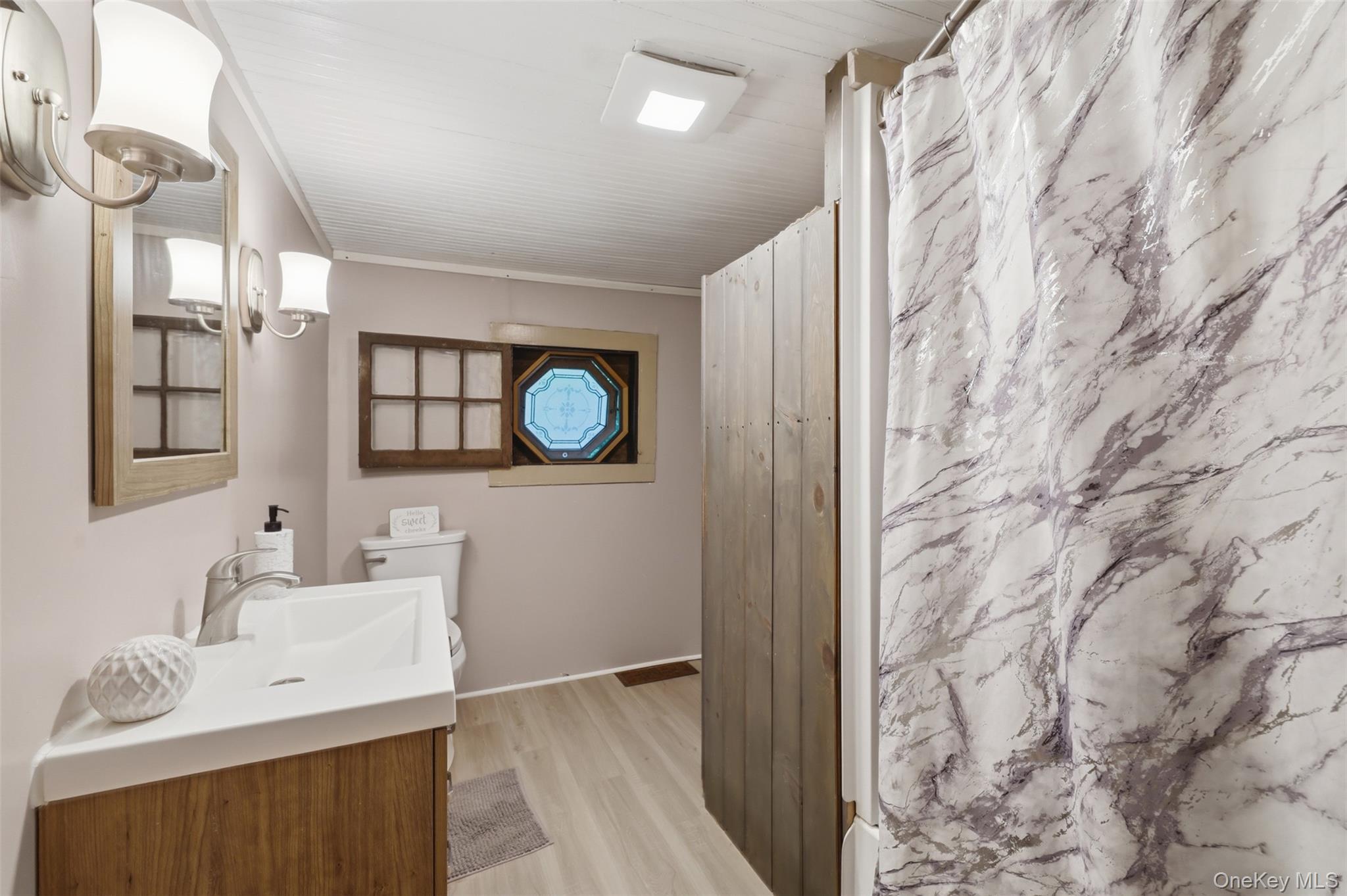 236 Hosner Mountain Road Hopewell Junction, NY 12533 - Photo 30 of 46 1st floor full bathroom featuring a wood-finish vanity and original stained glass window