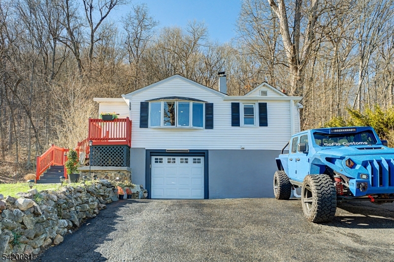 a front view of house with yard and trees