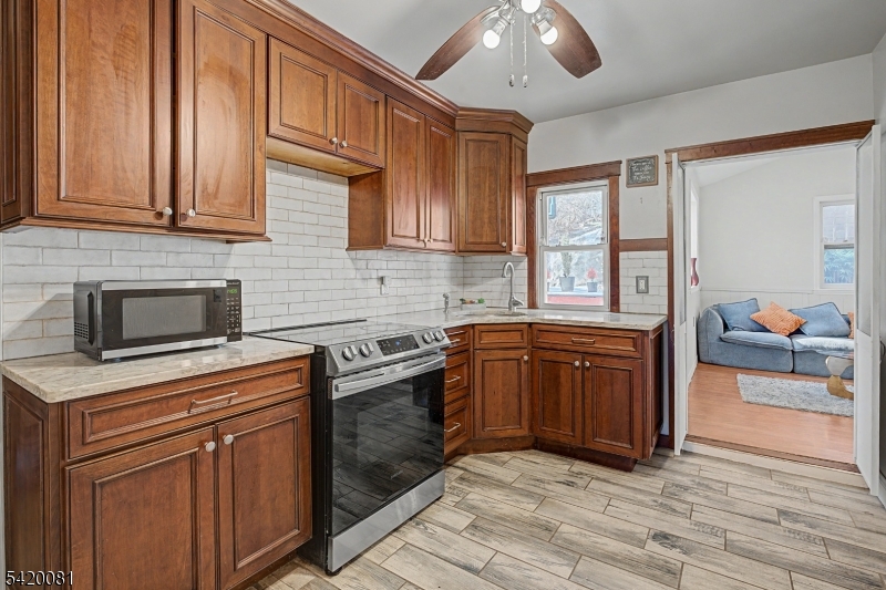 599 Berkshire Valley Road Wharton, NJ 07885 - Photo 14 of 20 a kitchen with stainless steel appliances granite countertop a sink stove and cabinets