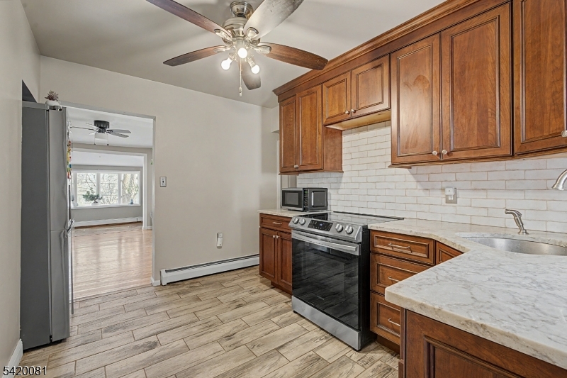 599 Berkshire Valley Road Wharton, NJ 07885 - Photo 15 of 20 a kitchen with stainless steel appliances granite countertop a sink stove and refrigerator