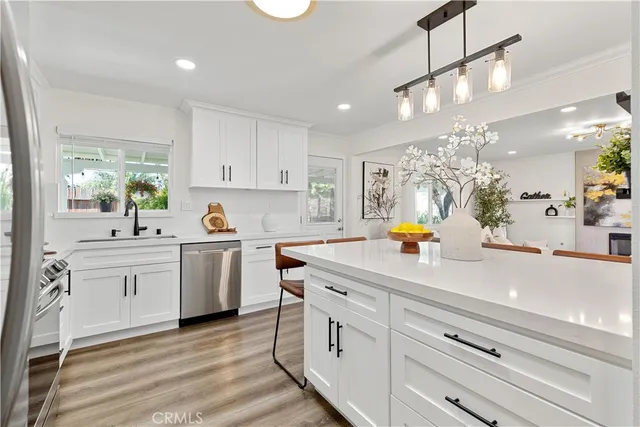 a kitchen with white cabinets and appliances