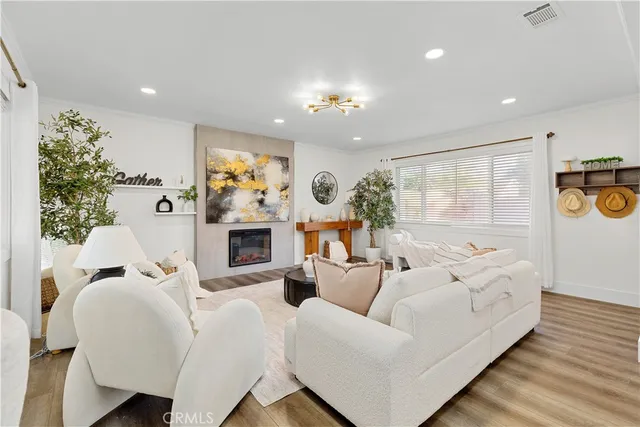 a living room with furniture a large window and a fireplace