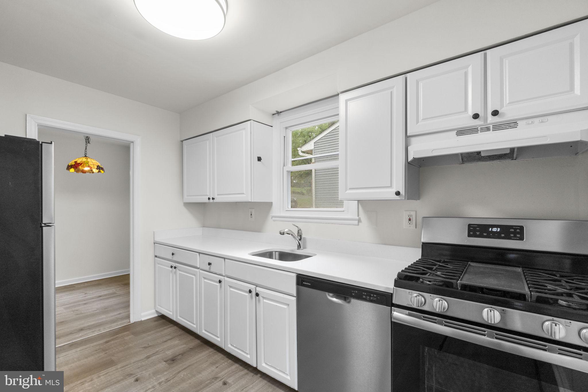3658 Clifmar Road Baltimore, MD 21244 - Photo 21 of 43 a kitchen with cabinets appliances a sink and a window