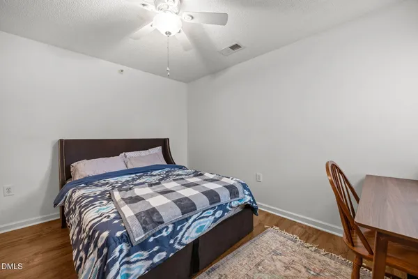 a bedroom with a bed and a chair