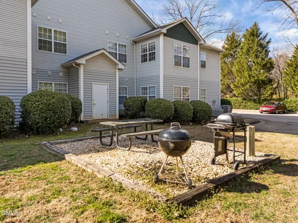 a view of a house with backyard water fountain and sitting area