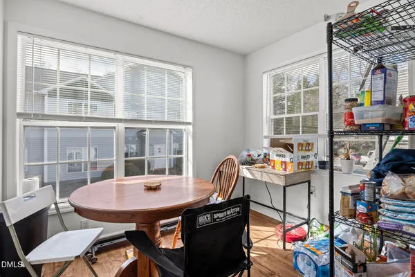 a view of a room that has a table and chairs
