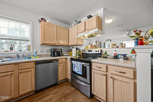 a kitchen with stainless steel appliances granite countertop a sink and cabinets
