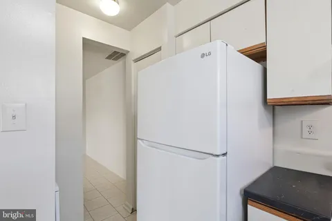 a white refrigerator freezer sitting inside of a kitchen