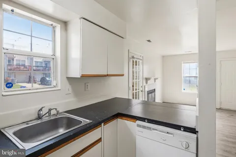 a kitchen with a sink cabinets and window