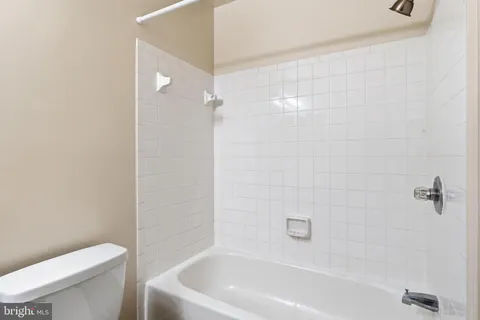 a bathroom with a toilet and bathtub