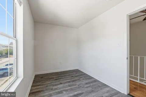 a view of an empty room and wooden floor