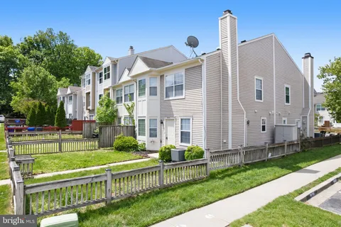 a front view of a house with a yard table and chairs