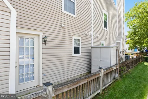a view of a house with backyard and a tree