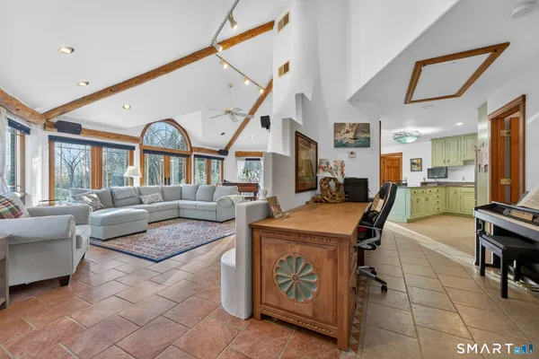 a living room with furniture a fireplace and a large window