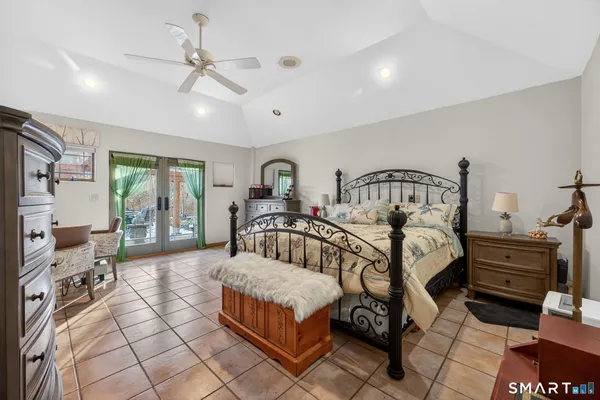 a bedroom with furniture and a large window