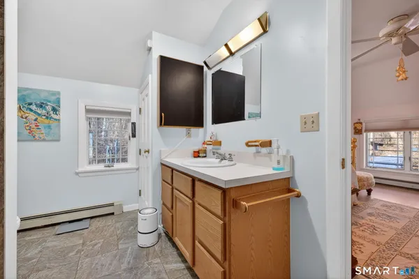 a bathroom with a sink toilet and mirror