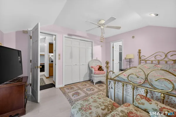 a bedroom with furniture and a flat screen tv