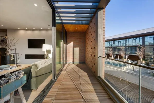 a living room with stainless steel appliances furniture a rug and a view
