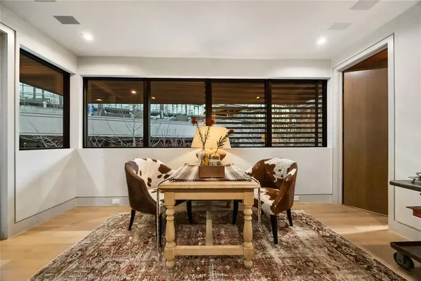 a living room with furniture a rug and a large window