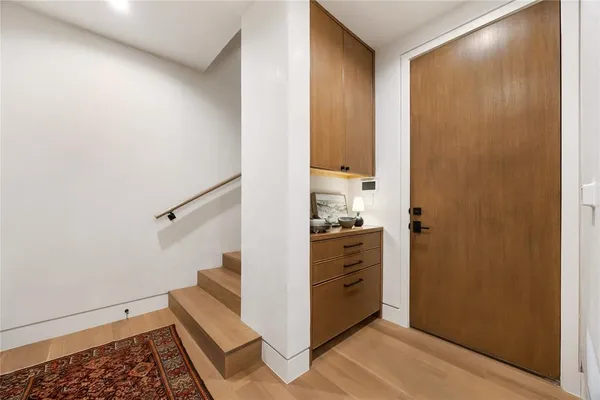 a view of entryway with wooden floor and a rug